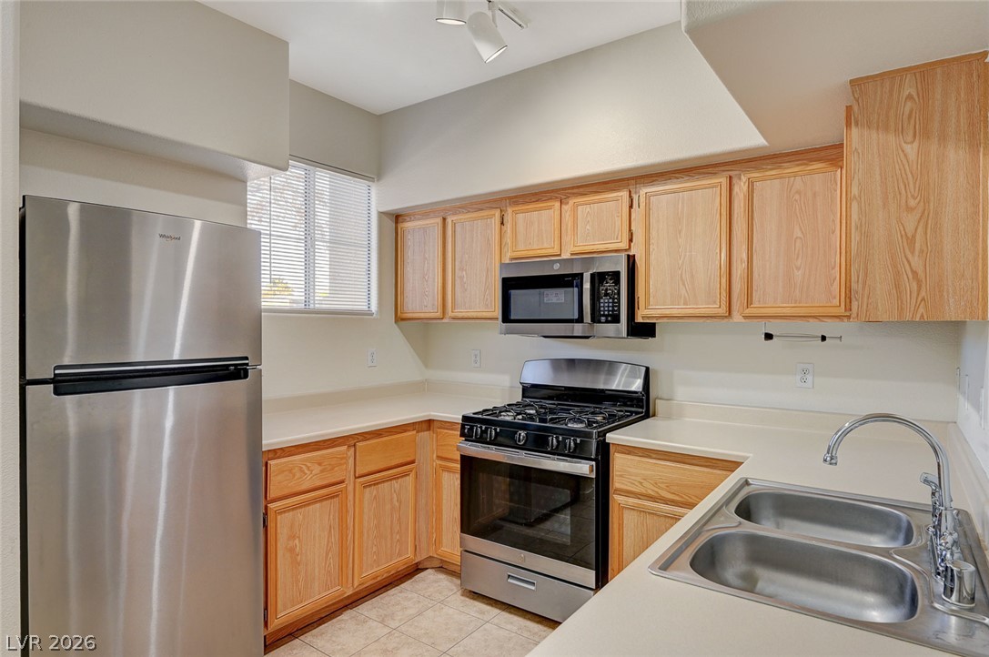 9050 West Warm Springs Road, Unit 1147 Las Vegas, NV 89148 - Photo 14 of 36 Functional kitchen with ample cabinet space and modern stainless steel appliances.