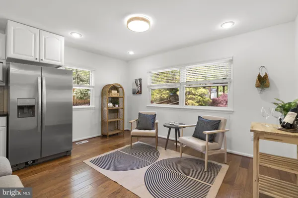 a open kitchen with stainless steel appliances granite countertop a stove and a wooden floors