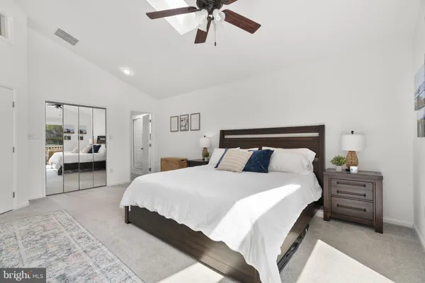a bedroom with a bed dresser and window