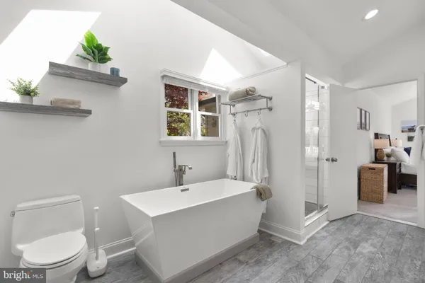 a bathroom with a tub and a window