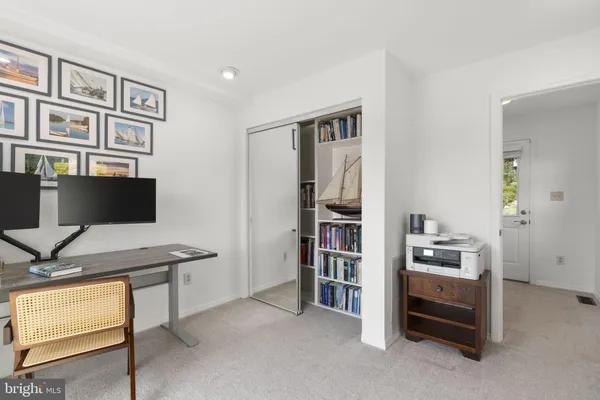 a work room with furniture and a floor to ceiling window