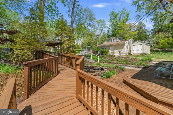 a view of a wooden deck and a garden