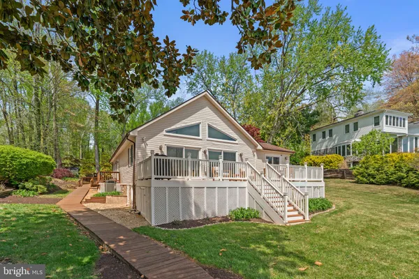 a view of a house with a yard and sitting area