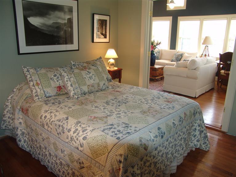 65 Bay Shore Road Hyannis, MA 02601 - Photo 13 of 35 a bed sitting in a bedroom next to a window with a large mirror and a couch