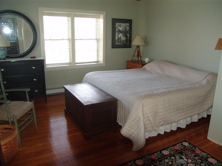 65 Bay Shore Road Hyannis, MA 02601 - Photo 14 of 35 a bedroom with a bed and a flat tv screen on the dresser
