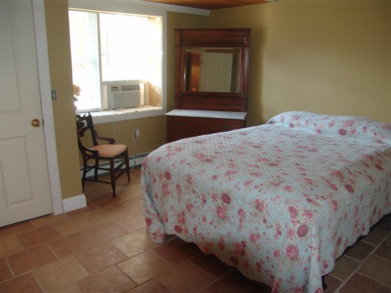 65 Bay Shore Road Hyannis, MA 02601 - Photo 27 of 35 a bedroom with a bed and a window