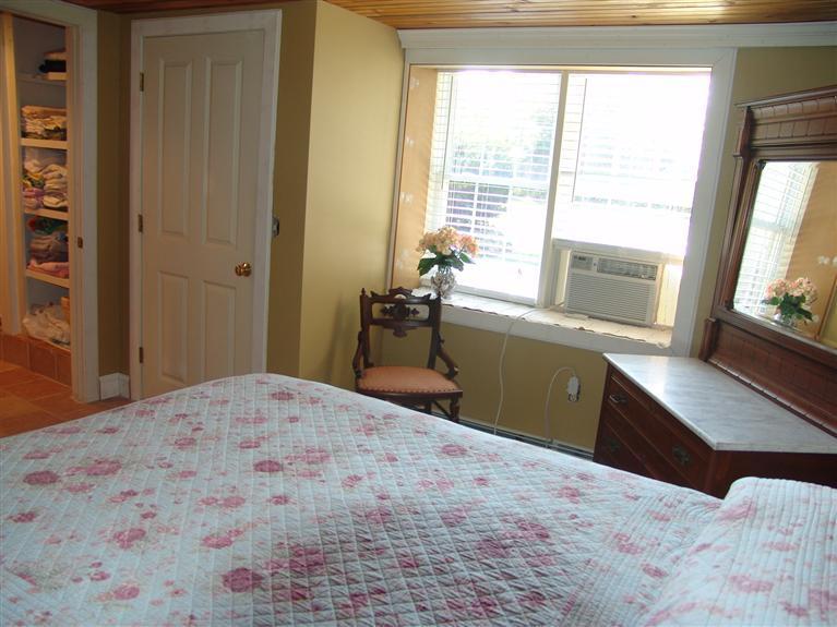 65 Bay Shore Road Hyannis, MA 02601 - Photo 28 of 35 a bedroom with a bed and a large window with outer view