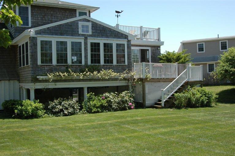 65 Bay Shore Road Hyannis, MA 02601 - Photo 3 of 35 a front view of a house with a garden