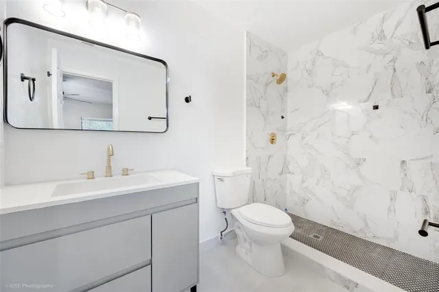 a bathroom with a sink a toilet and a mirror