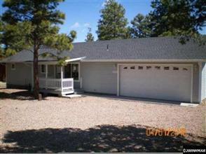 2224 Roundabout Way Overgaard, AZ 85933 - Photo 1 of 4 a backyard of a house