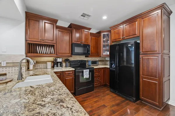 a kitchen with stainless steel appliances granite countertop a stove and a sink
