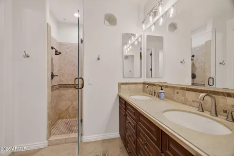 a bathroom with a double vanity sink a and mirror
