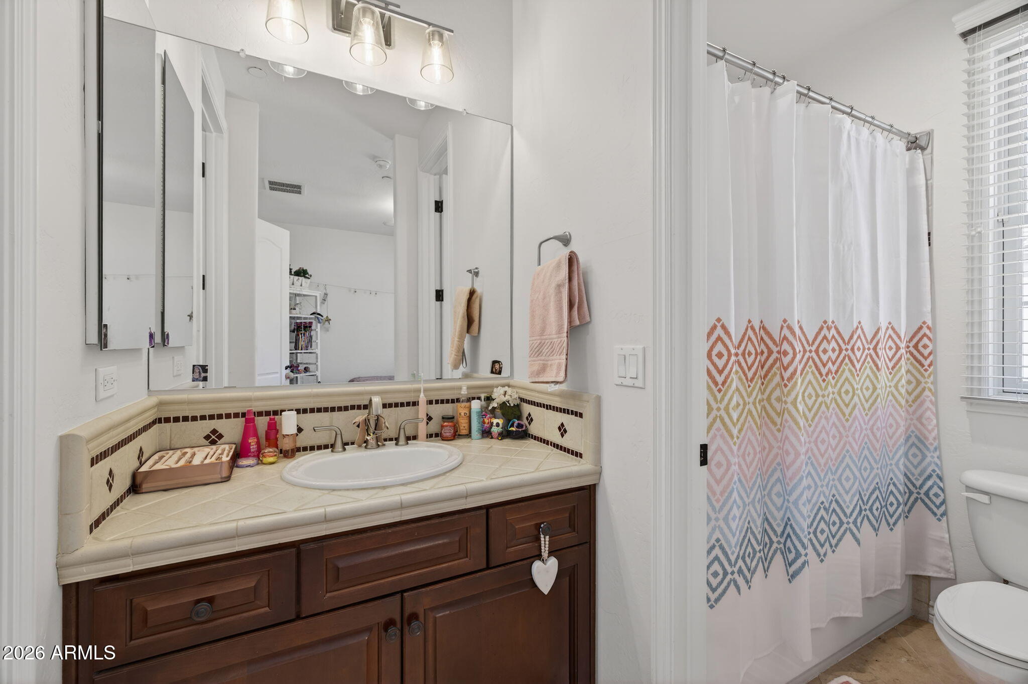 4423 North 24th Way Phoenix, AZ 85016 - Photo 22 of 29 a bathroom with a granite countertop sink and a mirror