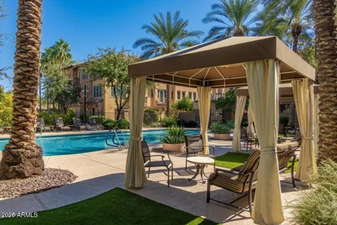 a view of a house with swimming pool and sitting area
