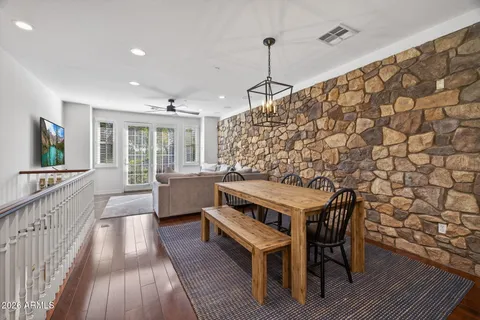 a living room with furniture and a ceiling fan