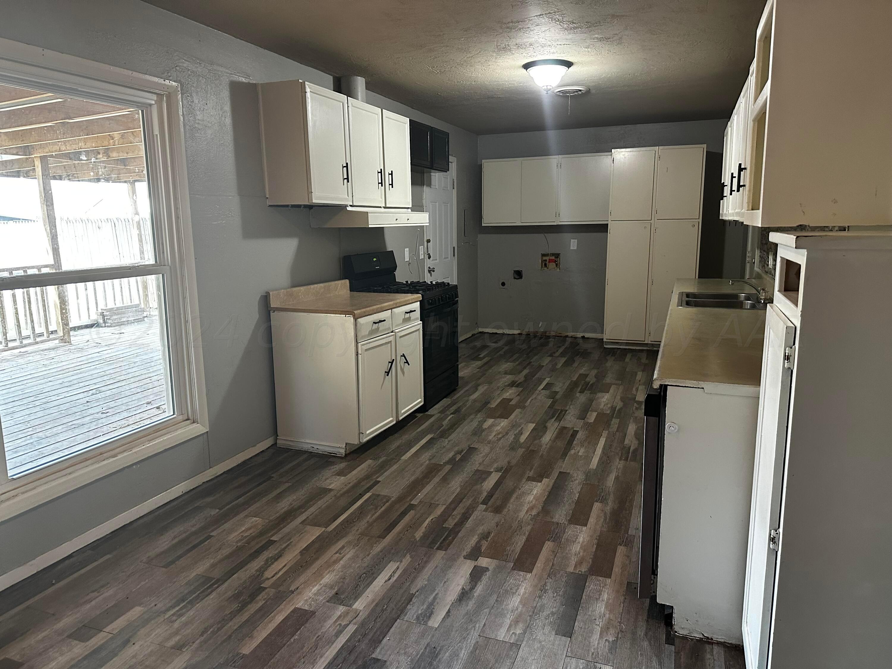 4209 Mesa Circle Amarillo, TX 79109 - Photo 4 of 9 a kitchen with refrigerator and window