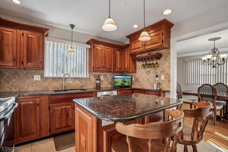 436 Mt Airy Road Bernards, NJ 07920 - Photo 8 of 20 a kitchen with a sink a center island and cabinets