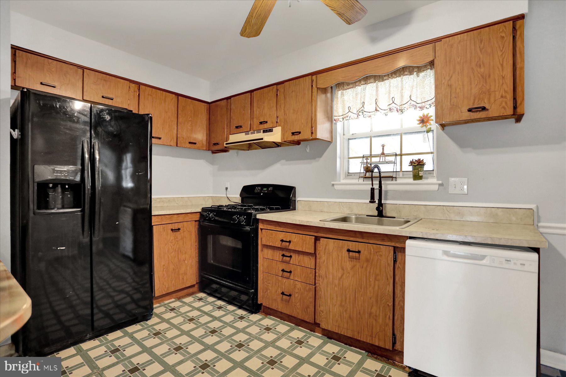959 Elm Road Baltimore, MD 21227 - Photo 6 of 27 a kitchen with stainless steel appliances granite countertop a refrigerator and a sink