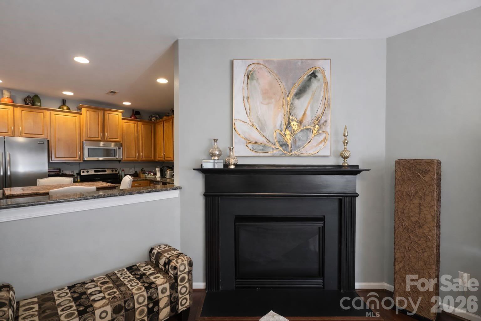 5670 Stafford Road Charlotte, NC 28215 - Photo 4 of 14 a kitchen with furniture a refrigerator and a view of living room