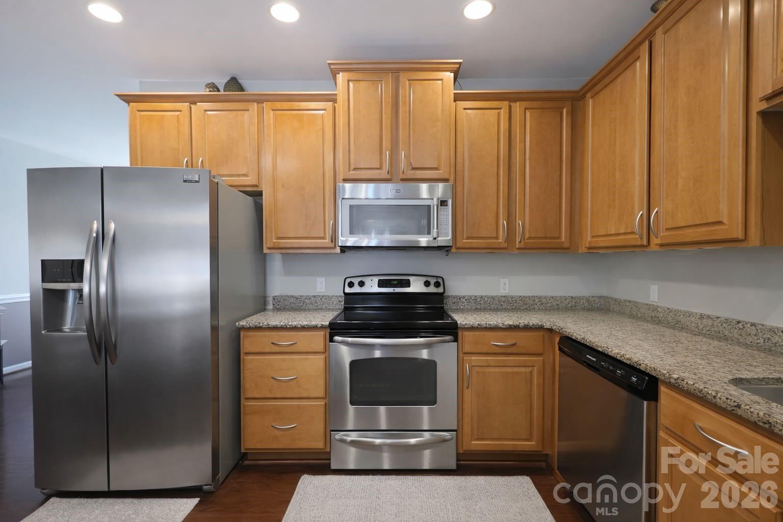 5670 Stafford Road Charlotte, NC 28215 - Photo 5 of 14 a kitchen with stainless steel appliances granite countertop a stove a refrigerator and a microwave