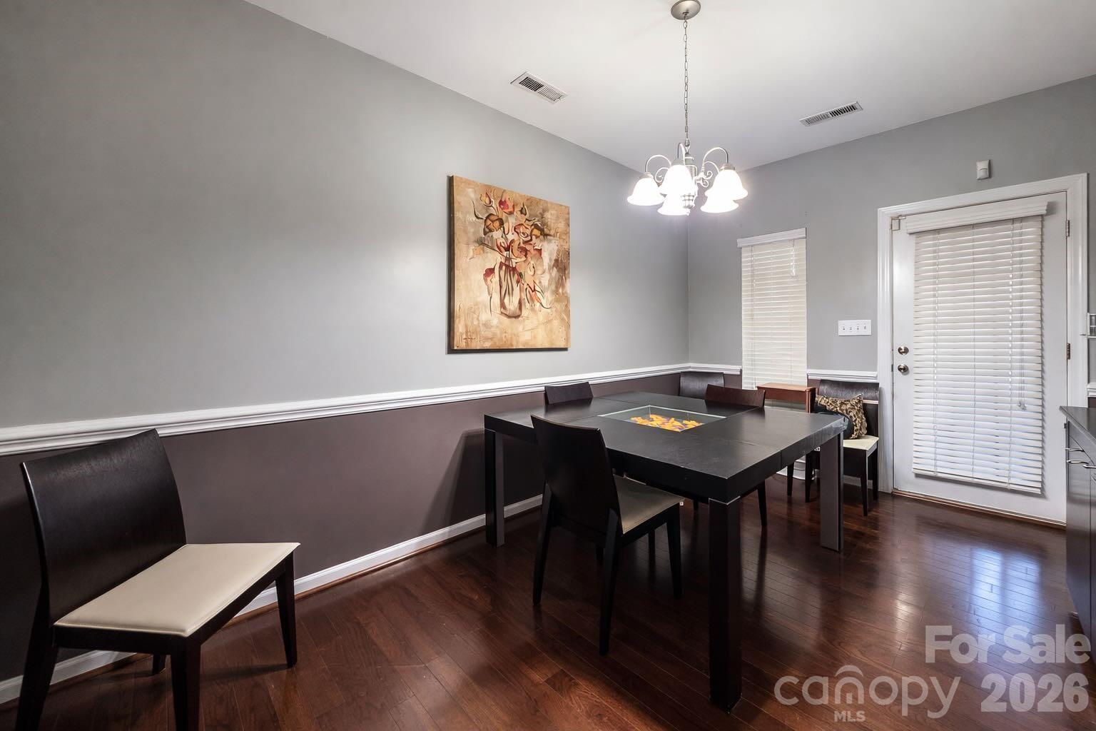 5670 Stafford Road Charlotte, NC 28215 - Photo 8 of 14 a view of a dining room with furniture wooden floor and chandelier