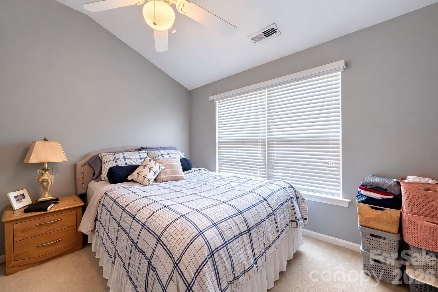 5670 Stafford Road Charlotte, NC 28215 - Photo 9 of 14 a bedroom with a bed and a chandelier