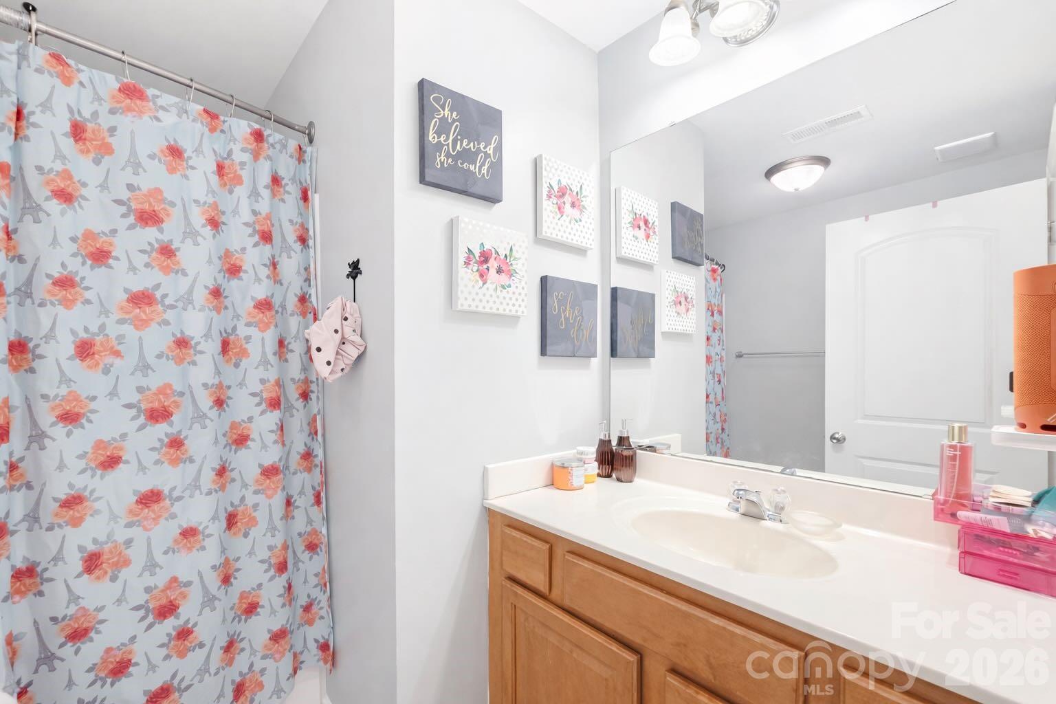 5670 Stafford Road Charlotte, NC 28215 - Photo 10 of 14 a bathroom with a sink and a mirror