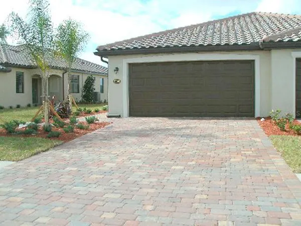 a front view of a house with outdoor seating yard and barbeque oven