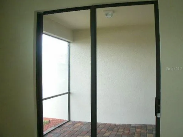 a view of a bathroom from a glass door