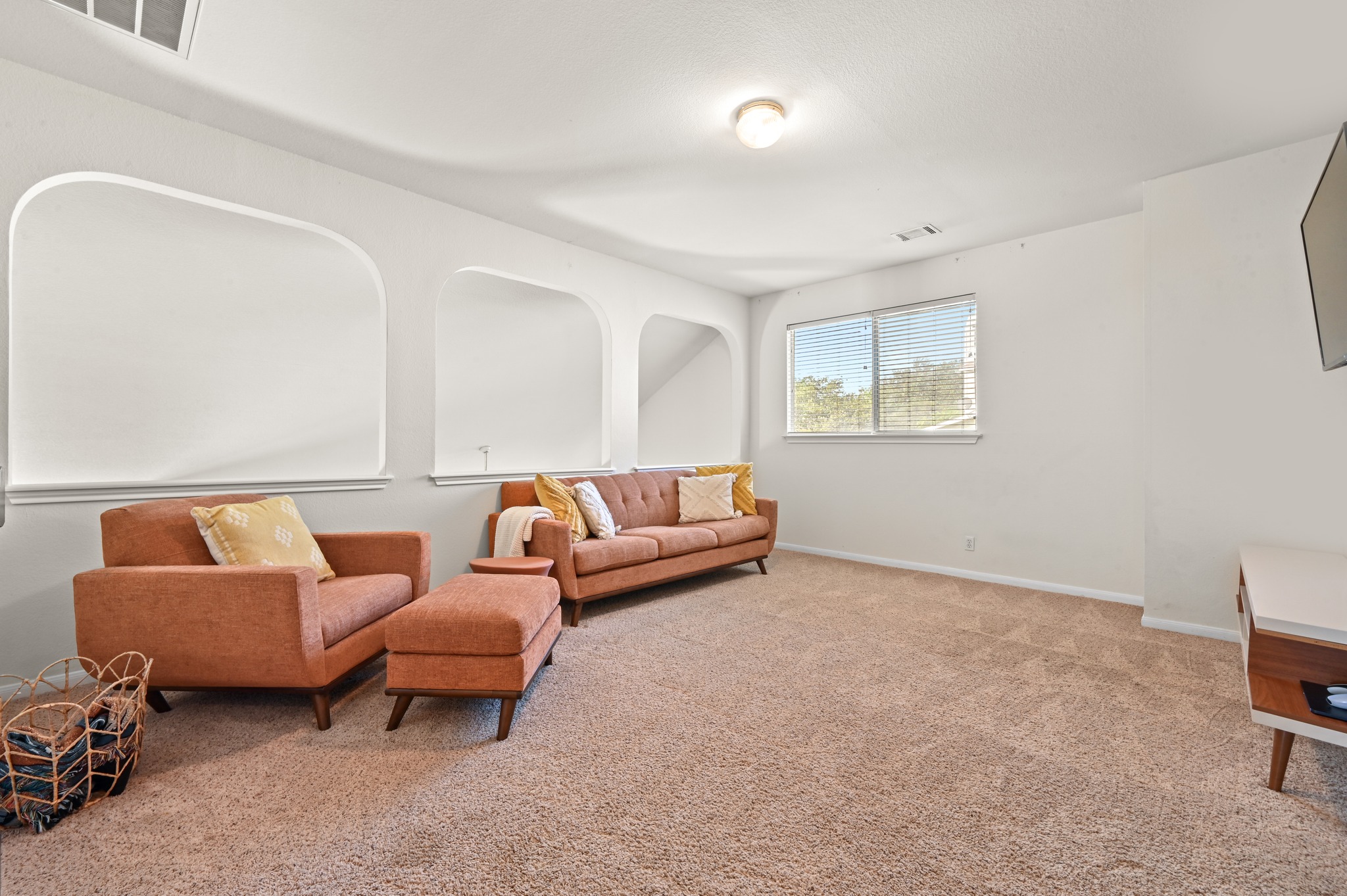 5888 Fergus Kyle, TX 78640 - Photo 18 of 40 A generous bonus room offers cozy carpeted comfort and abundant natural light through a wide window.