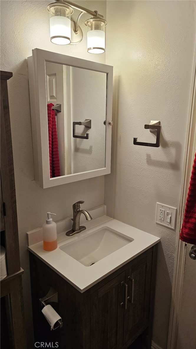 8710 Wahl Street Santee, CA 92071 - Photo 11 of 19 a bathroom with a sink vanity and a mirror