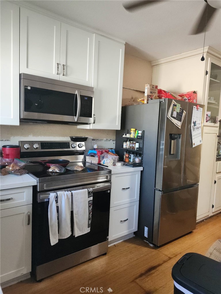 8710 Wahl Street Santee, CA 92071 - Photo 7 of 19 a kitchen with stainless steel appliances granite countertop a refrigerator stove and sink