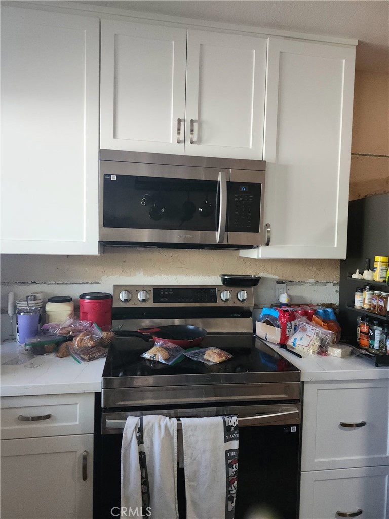 8710 Wahl Street Santee, CA 92071 - Photo 8 of 19 a kitchen with a stove and a microwave