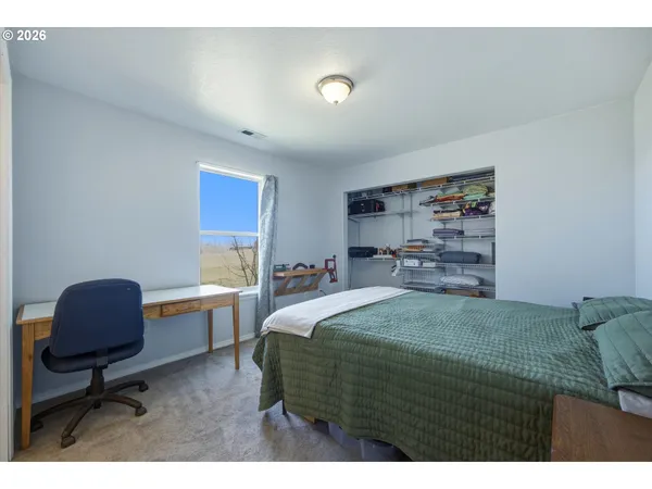 a bedroom with a bed and a chair