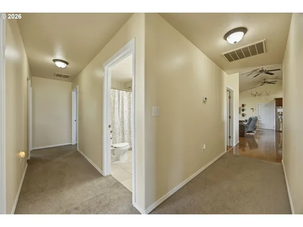 a view of a hallway with wooden floor and entryway