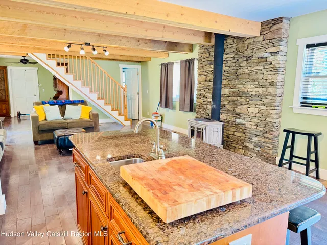 a kitchen with a stove and a wooden floor