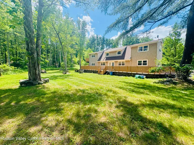 a front view of house with yard and green space