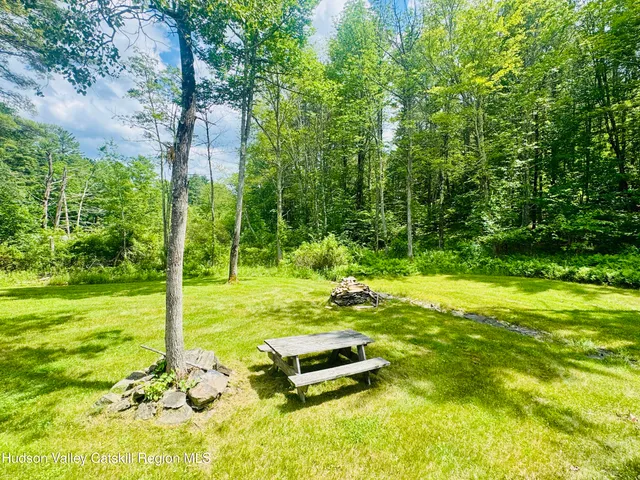 a view of a backyard with swimming pool