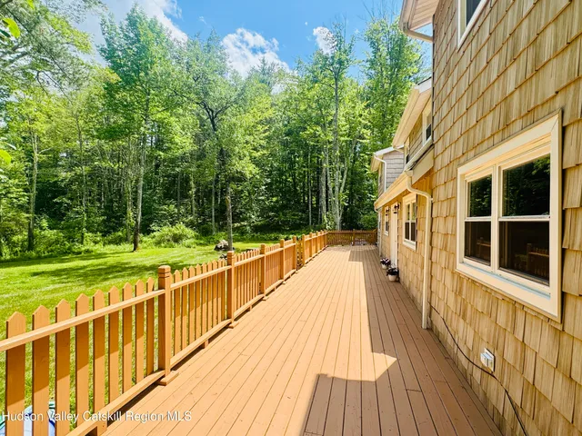 a view of a balcony with wooden floor and fence