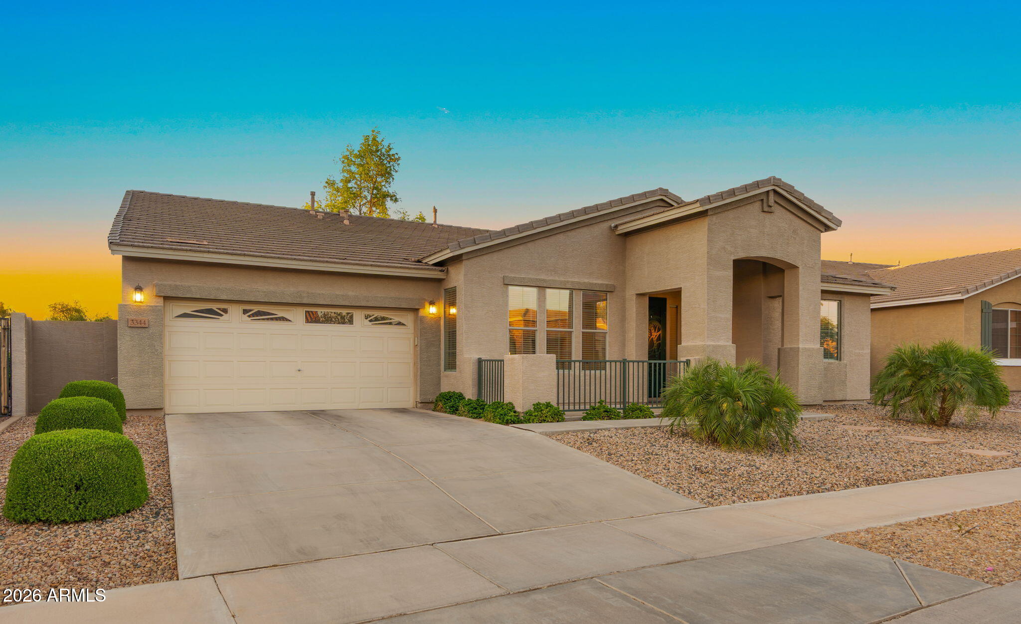 3344 East Hopkins Road Gilbert, AZ 85295 - Photo 2 of 32 a front view of a house with a yard and garage