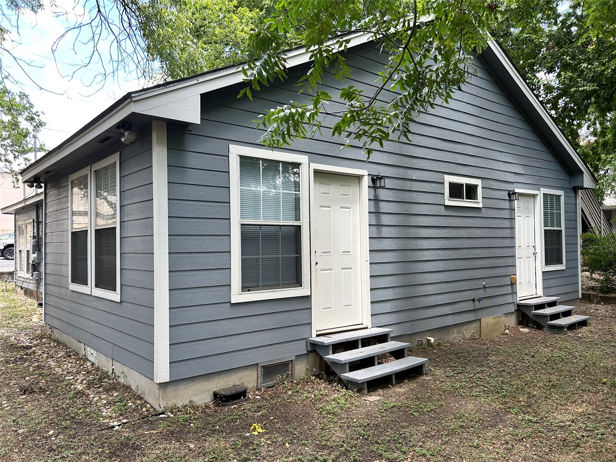 3105 Kings Lane Austin, TX 78705 - Photo 12 of 12 a view of a small house with a yard and large tree
