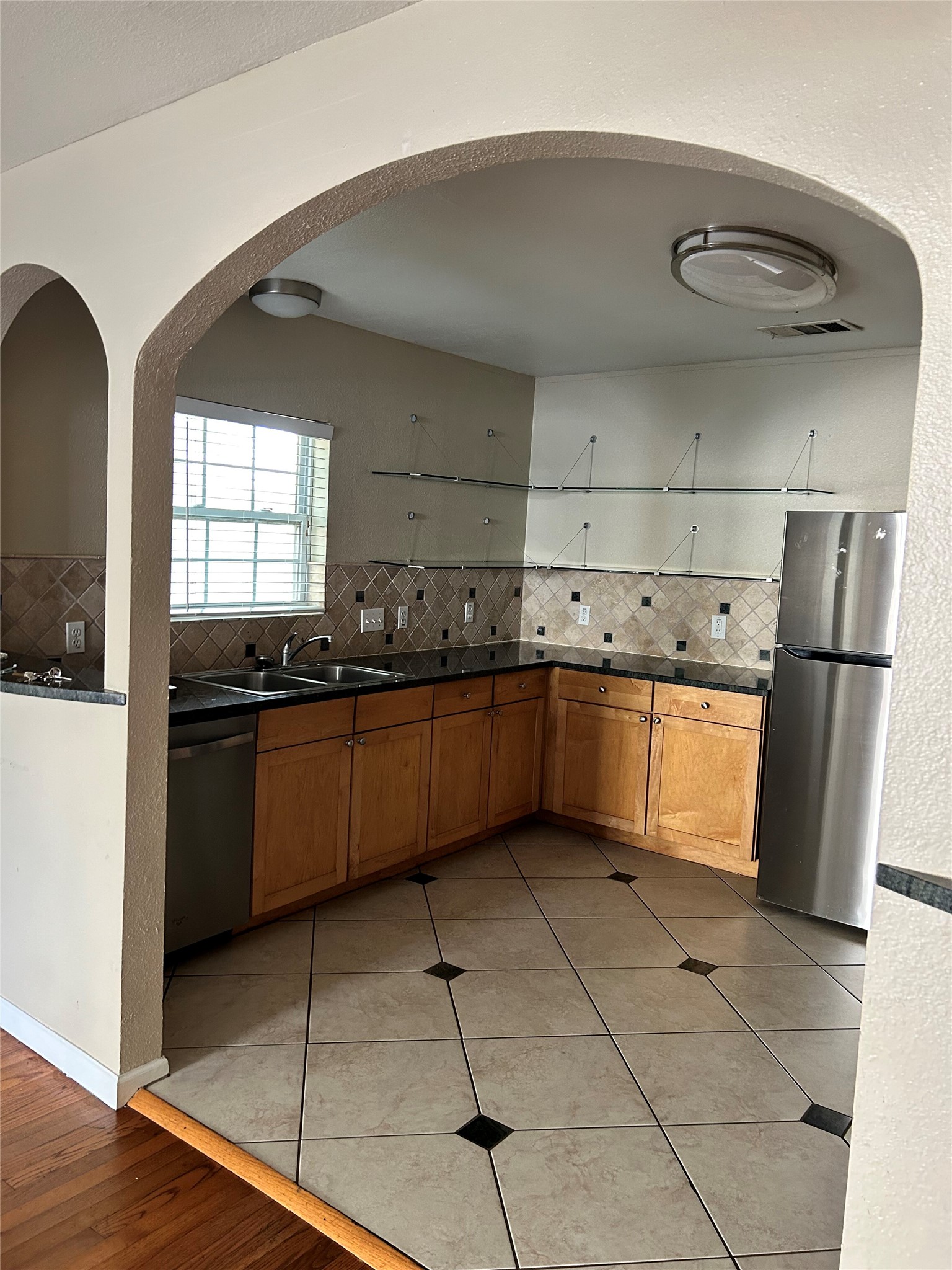3105 Kings Lane Austin, TX 78705 - Photo 10 of 12 a kitchen with a sink a refrigerator and cabinets
