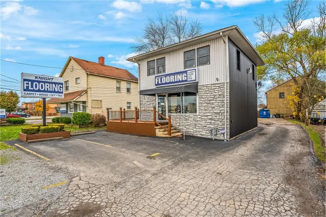 a view of a house with a yard and garage