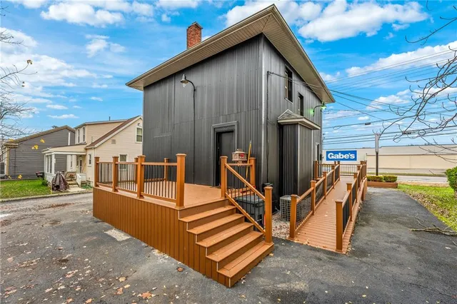 a view of a house with backyard and sitting area