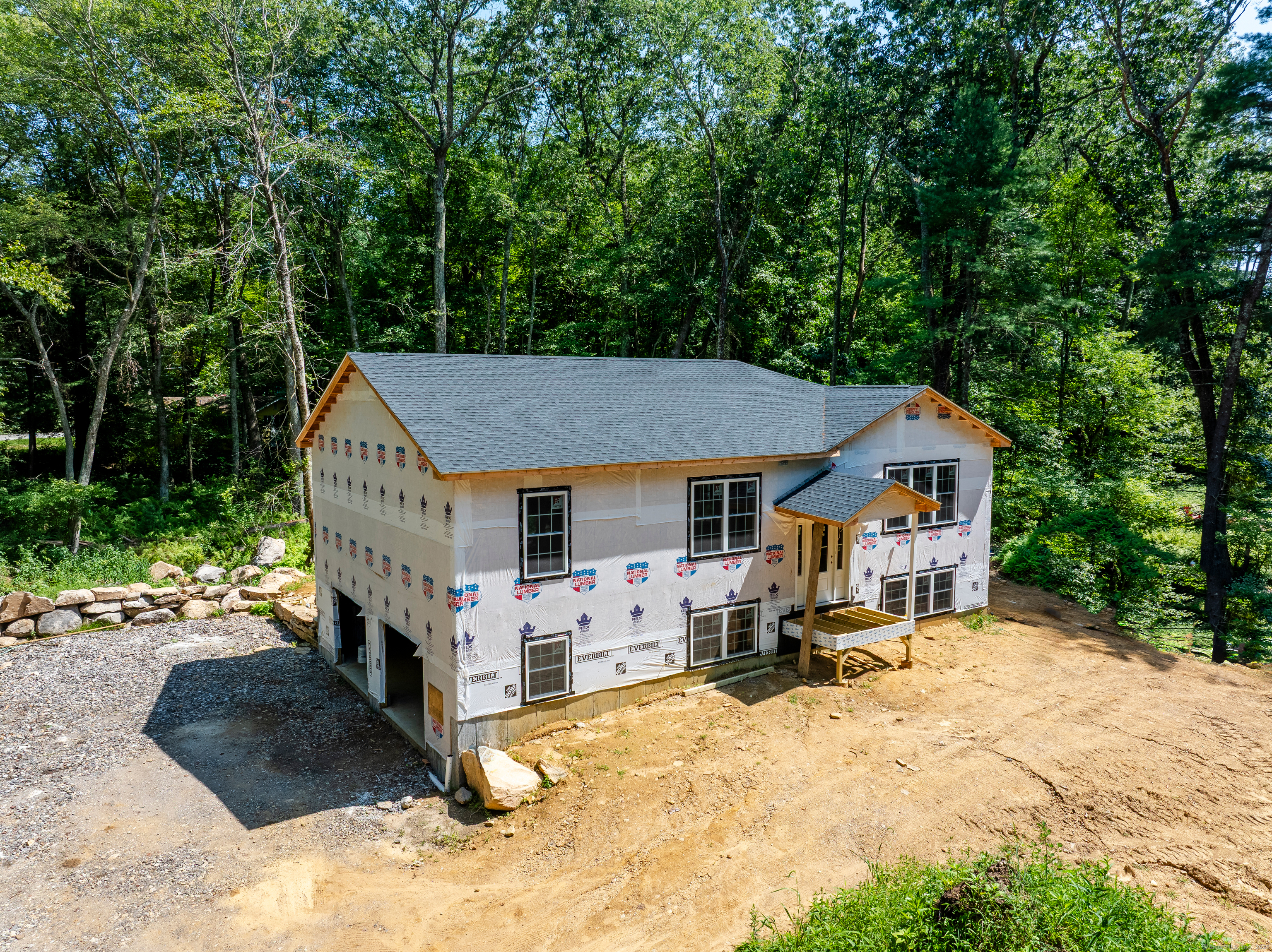 a view of a house with a yard covered with snow in the background