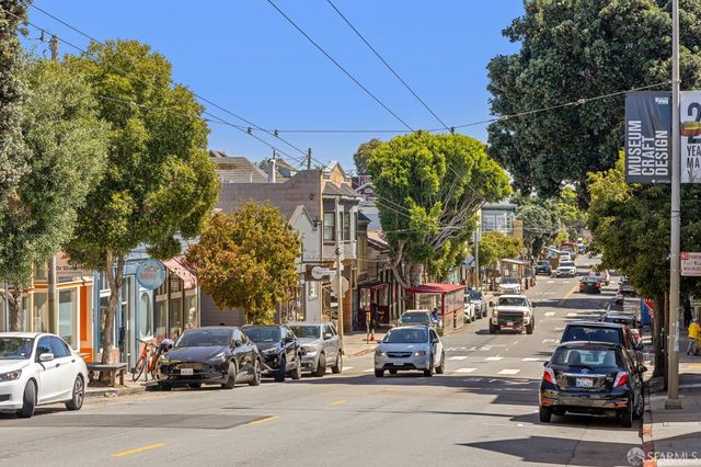 a view of a cars parked on the side of a street