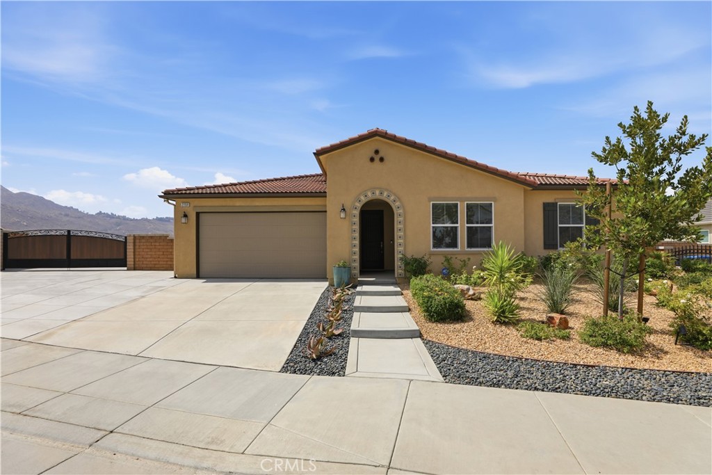 21159 Blue Jeans Court Riverside, CA 92507 - Photo 3 of 63 a front view of a house with garden