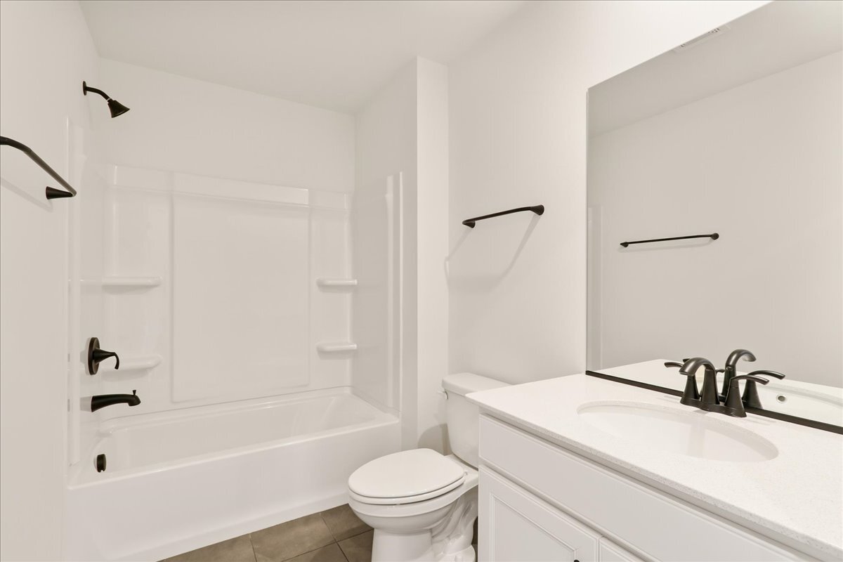 2216 Ryegrass Lane, Unit 78002 Bolingbrook, IL 60490 - Photo 26 of 29 a bathroom with a sink a toilet and a bathtub