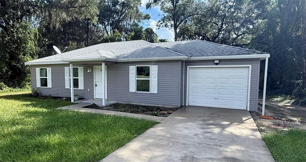 460 Locust Road Ocala, FL 34472 - Photo 1 of 1 a front view of a house with a garden