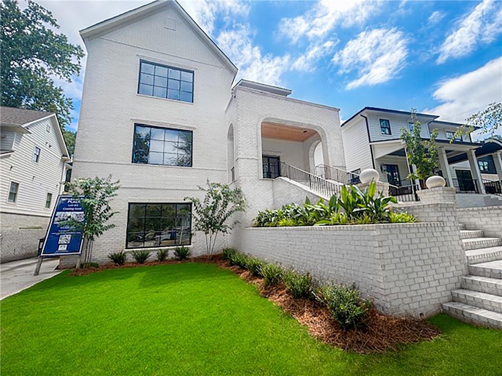 1366 Wessyngton Road Northeast Atlanta, GA 30306 - Photo 1 of 29 a front view of a house with a garden and plants